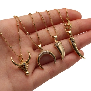 Gold-plated ball chain necklace with bull head and crescent moon pendant charms