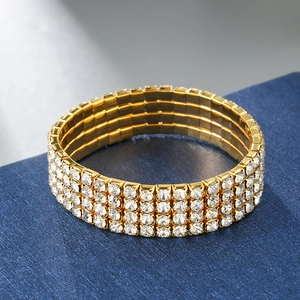 Close-up of four-row elastic gold bracelet with shimmering crystals on blue display