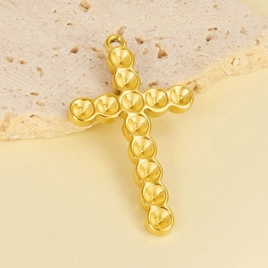 Macro view of 18K gold-plated stainless steel cross pendant with circular groove details