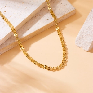 Elegant gold-plated stainless steel fox tail chain necklace on a minimalist stone display