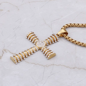 Close-up of hip hop cross pendant with white rhinestones on golden box chain
