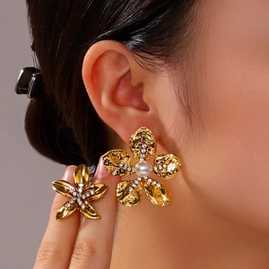 French style 18K gold plated flower earrings with pearls and diamonds on a model