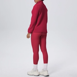 Vista laterale del set sportivo rosso con giacca a maniche lunghe e leggings