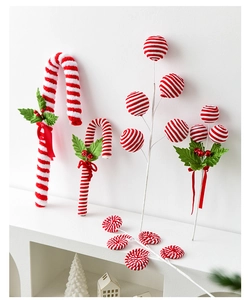 Detailed view of plush red and white Christmas candy canes and swirl lollipop decor