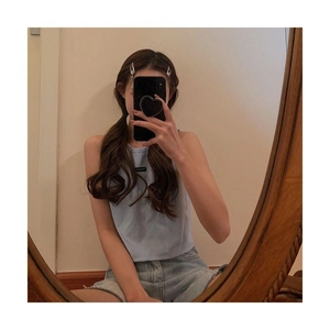 Close-up of a light blue sleeveless crop top and frayed denim shorts for a casual summer look
