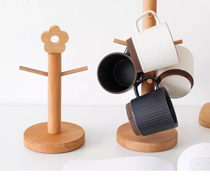 Detailed view showing the solid wood cup holder both empty and holding ceramic mugs