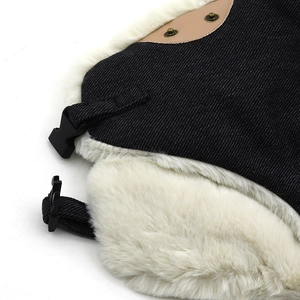 Detail of winter trapper hat showing black denim fabric and white faux fur lining