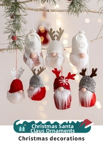 Detail of seven plush Christmas gnomes with sequins and knitted hats hanging on branches