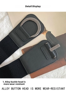 Detailed macro of vintage alloy buckle with engraved texture on black elastic belt