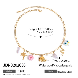 Detailed view of gold stainless steel necklace with palm tree and flower charms