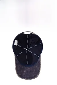Detail of vintage washed denim cap interior showing embroidered tape and stitching