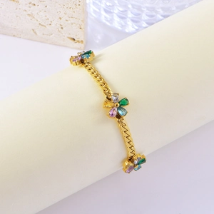 Golden flower bracelet with colorful zircons on cuban chain shown in lifestyle setting