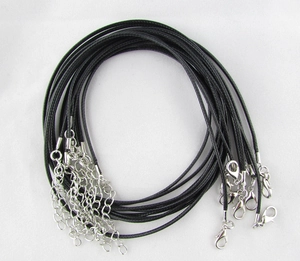 Detail showing black waxed cord necklace with lobster clasp and adjustable metal chain