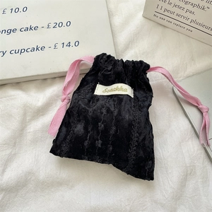 Velvet drawstring pouch in black with pink cords for lipstick and earphone storage