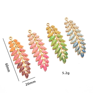 Macro detail of leaf-shaped colorful pendants showing size 60x20mm and 5.2g weight