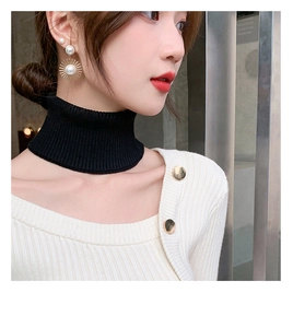 Detail of black ribbed knit turtleneck neck warmer showing stretch texture on neck