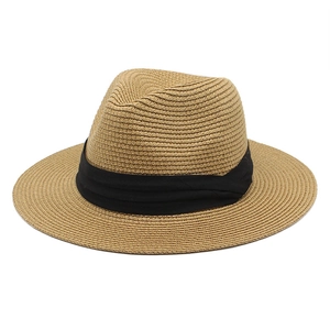 Detailed close-up of woven texture and black ribbon band on Panama straw fedora hat