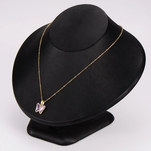 Elegant gold butterfly necklace with purple crystals on a black display stand