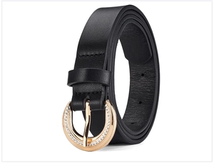 Detail of elegant black leather belt with gold round buckle encrusted with rhinestones