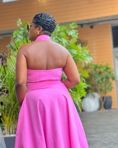 Detail view of pink backless halter maxi dress with textured fabric and floor length