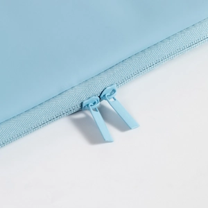 Close-up of dual zipper detail on the light blue waterproof tablet sleeve case