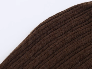 Macro view of dark brown ribbed knit fabric texture on this two-piece skirt set