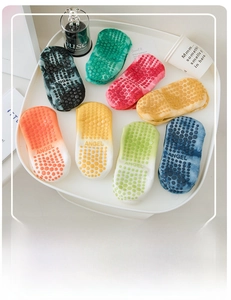 Detailed view of tie-dye yoga socks with non-slip silicone grips and Angel embroidery