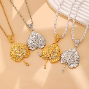 Detail of crystal-encrusted maple leaf pendants in gold and silver finishes