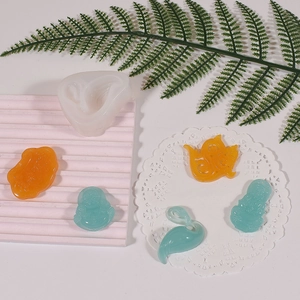 Macro detail of swan and Buddha resin molds with finished DIY silicone craft pieces