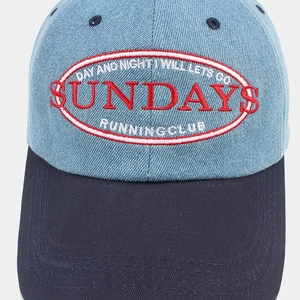 Detail of Sundays embroidery on denim patchwork baseball cap with reinforced stitching