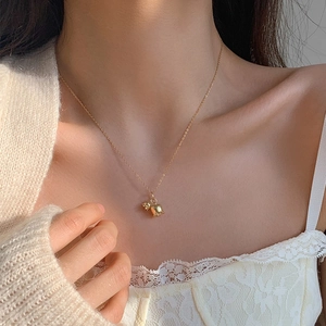 Elegant gold tulip pendant necklace worn by a model on a delicate chain for women