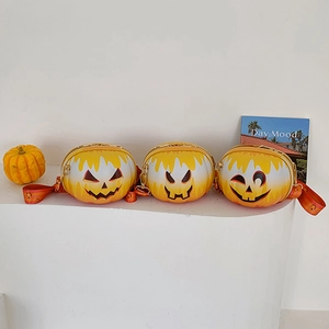 Detailed view of three pumpkin-shaped crossbody bags with gradient orange Halloween faces
