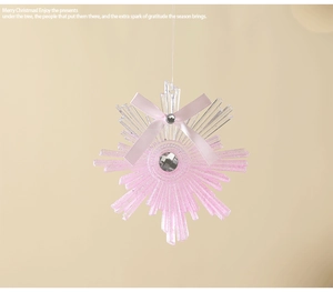 Close-up of pink snowflake ornament with acrylic glitter finish and diamond-like center