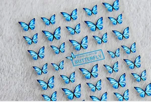 Detailed view of blue 5D butterfly nail art stickers on high-definition adhesive film