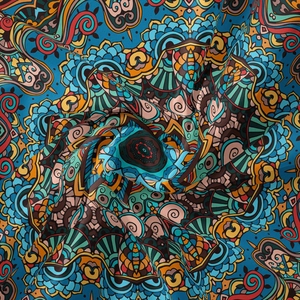 Detail of bohemian mandala tapestry fabric showing soft pleats and vibrant floral patterns