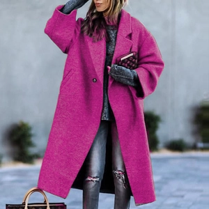 Detail shot of long fuchsia wool coat with lapel collar and buttoned front styling