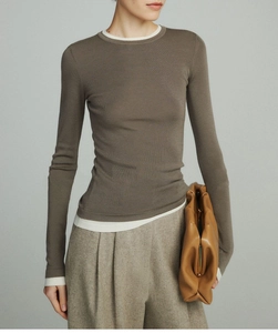Detail of slim fit wool knit sweater with mock layered contrast collar and cuffs