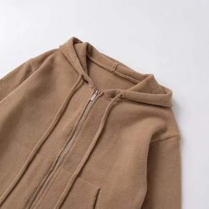 Women's brown knitted zip-up hoodie featuring drawstring detail and soft cozy fabric