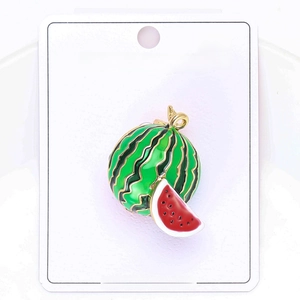 Detail of round watermelon alloy brooch with enamel drip oil finish on white card