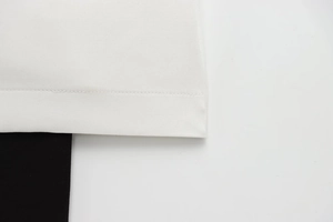 Macro view of high-quality stitching and black-white patchwork on the dress hem