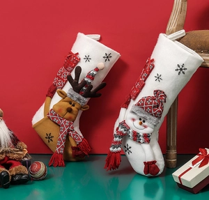 Detailed view of festive white felt Christmas stockings with 3D reindeer and snowman characters
