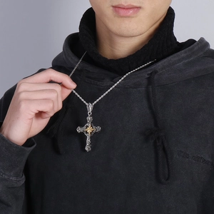 Retro punk stainless steel cross necklace with gold star detail on male model