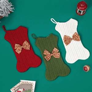 Knitted bone-shaped Christmas stockings with bows, set of three for holiday decoration