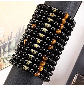 Detailed view of zodiac bead bracelets with tiger eye stones on black display stand