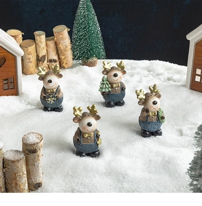 Detailed close-up of four resin reindeer figurines in a snowy Christmas scene display