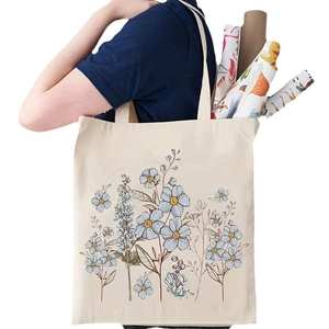 Off-white canvas tote bag featuring light blue floral patterns and spacious design