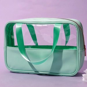 Detail view of mint green waterproof PVC makeup bag with PU leather trim and zipper