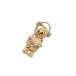 Sparkling gold bear brooch with headphones and clear rhinestones on white background