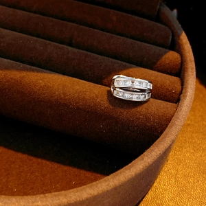 Macro shot of silver ring with double-row square-cut cubic zirconia in a velvet display box
