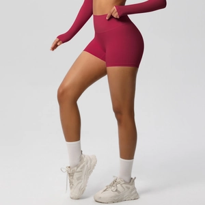Side view of high-waisted seamless scrunch yoga shorts in deep rose red on fitness model